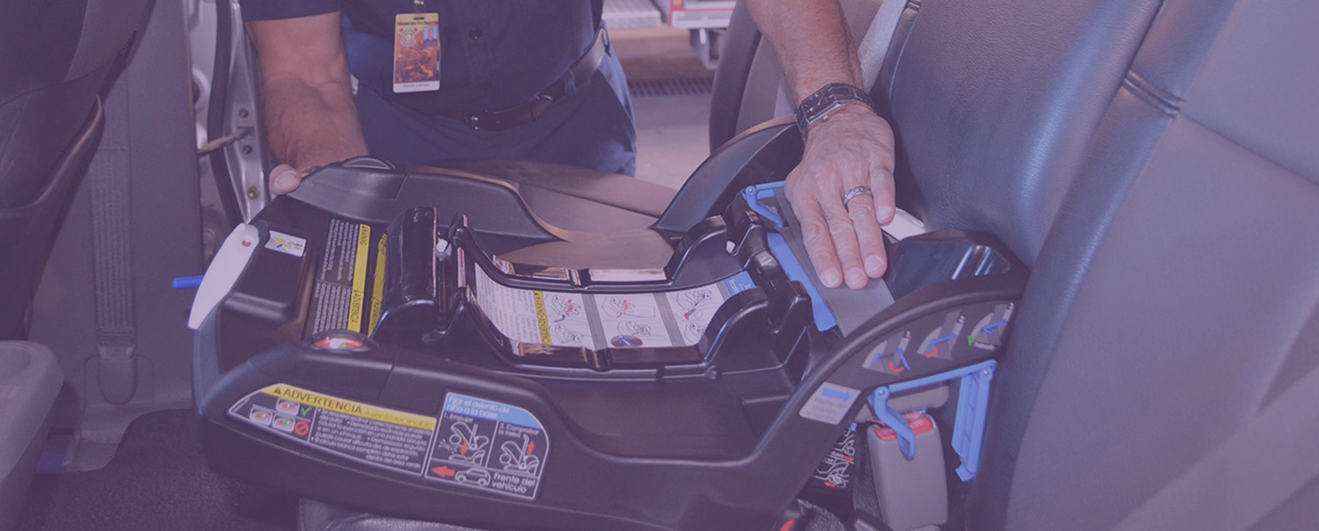 A police officer installs a child safety seat in a car